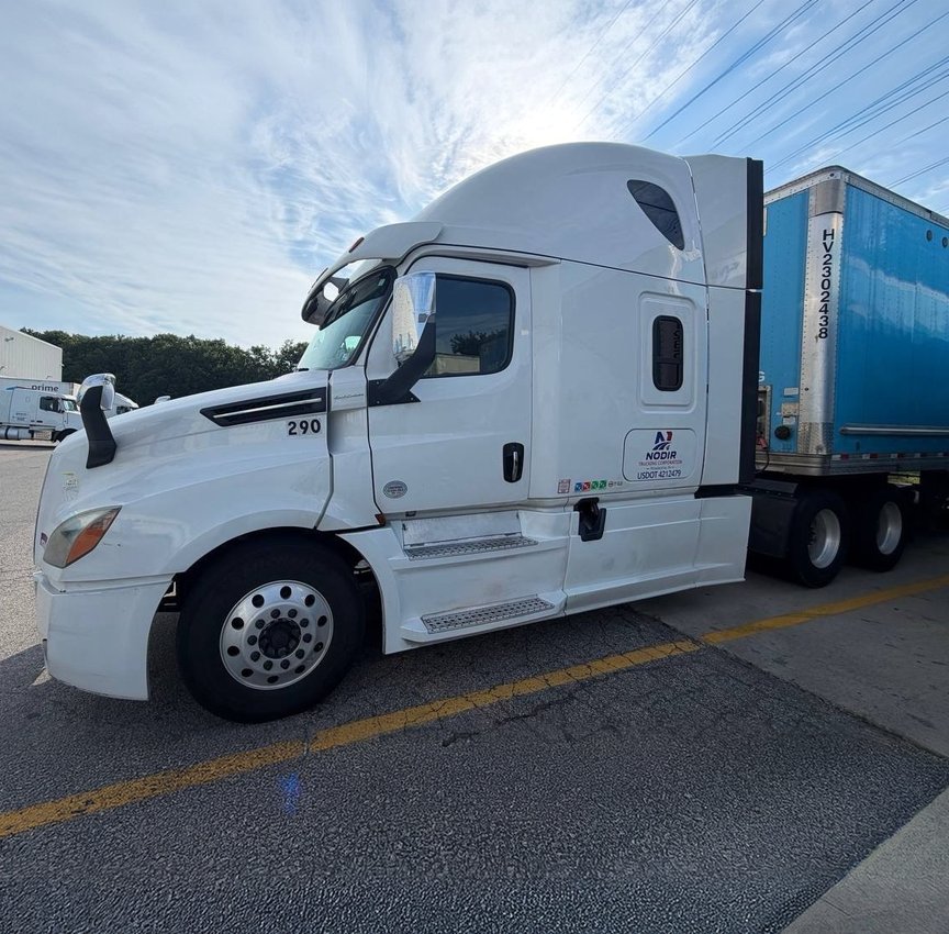 White tractor unit with an Amazon trailer